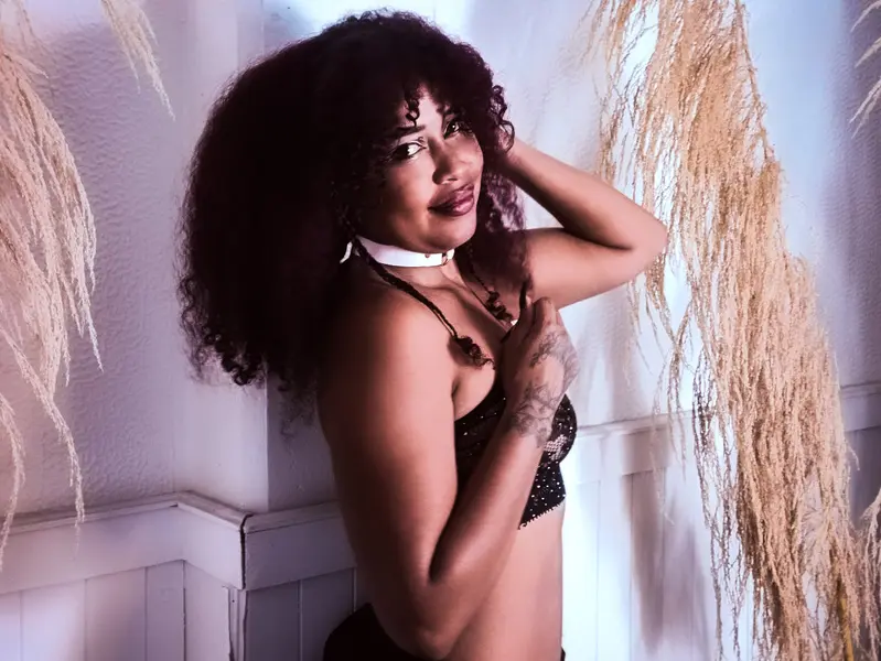 Young woman in a red lace bikini relaxing in a room with blue neon lighting.