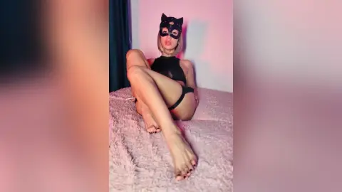 Woman in black cat mask and lingerie sitting on a bed in a moody, pink-lit room.