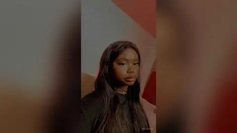 KeianHoz looks at the camera with long dark hair and a gold choker necklace.