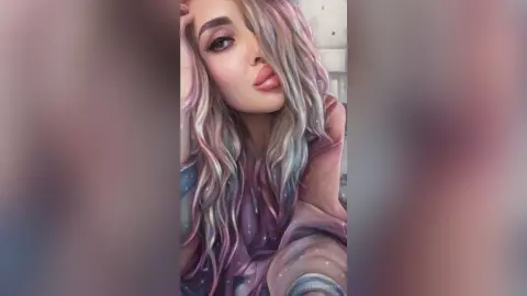 Portrait of a woman with long pastel pink hair wearing a cozy sweater in a soft, dreamy aesthetic mood.