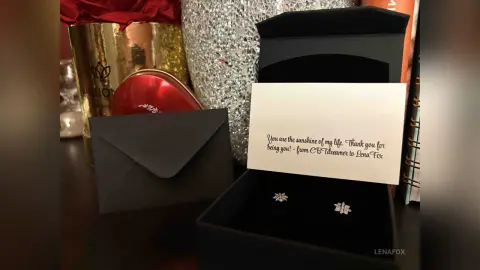 Romantic gift set featuring a heartfelt note, red heart box, and sparkling diamond earrings in a black gift box.