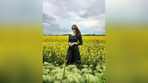 JennyStormy — Lady in black in a rapeseed field