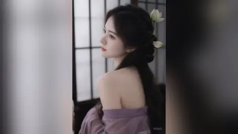 Elegant woman in a purple silk dress with long dark hair posing in a serene, traditional indoor setting.