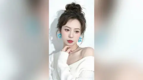 Elegant woman in a white off-the-shoulder sweater wearing blue flower earrings in a bright, minimalist setting.