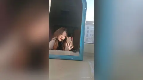 JosefinaHancin takes a mirror selfie, showing her long brown hair and face while holding a phone in a room with a window.