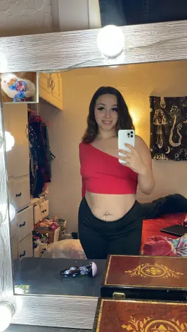Princess1234 poses in a red tube top and black leggings, showing her bare stomach and navel in a mirror selfie.