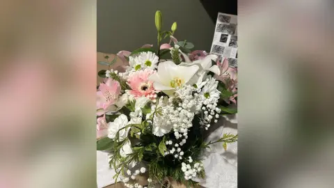 Beautiful bouquet of pink lilies, white daisies, and baby's breath in a romantic floral arrangement.