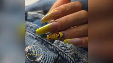 Long yellow Pikachu themed nail art design on manicured fingernails held against blue denim fabric.