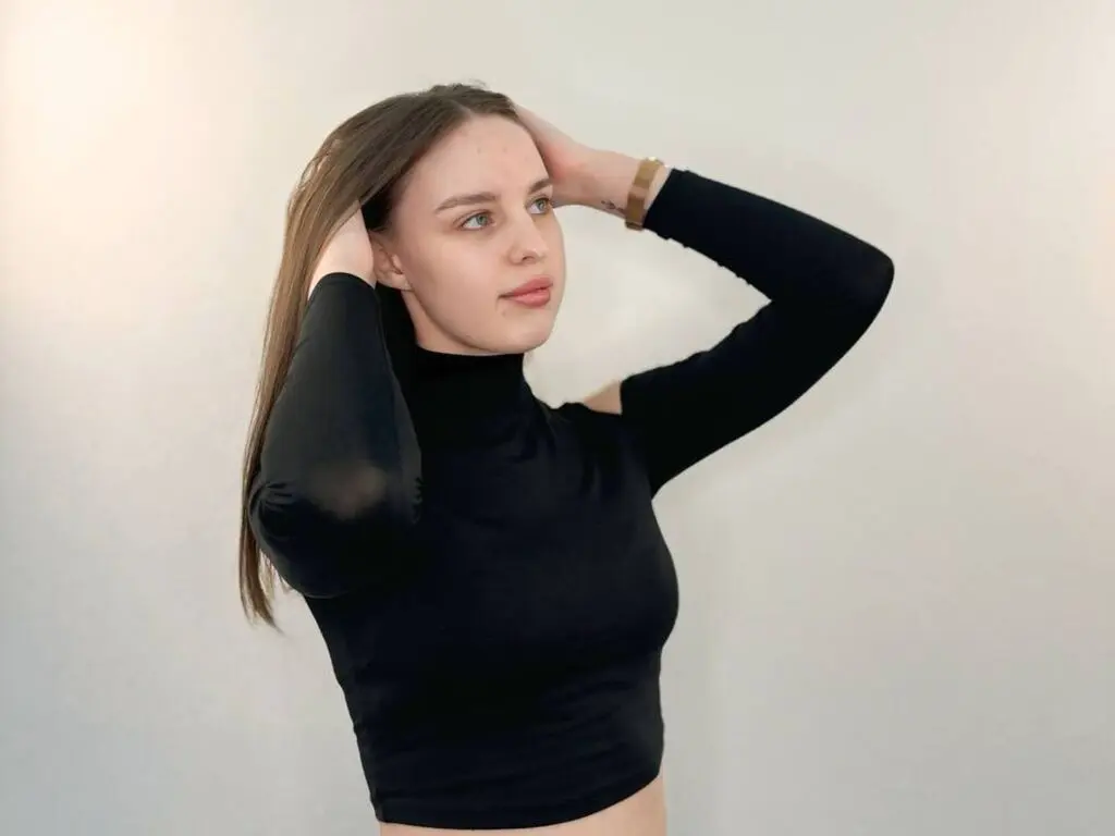 Young woman in a black long-sleeve turtleneck posing against a white background with a minimalist mood.