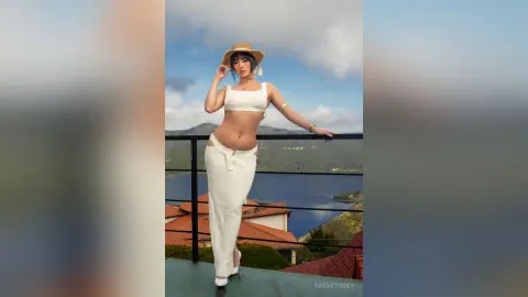 Stylish woman in a white crop top and long skirt posing on a balcony overlooking a scenic lake view.