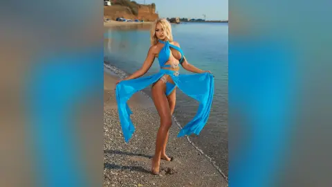 Anastasia stands on a sandy beach wearing a light blue halter-neck bikini that exposes her stomach and hips.
