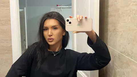 JadaJosey takes a mirror selfie wearing a black long-sleeve shirt and a silver necklace.