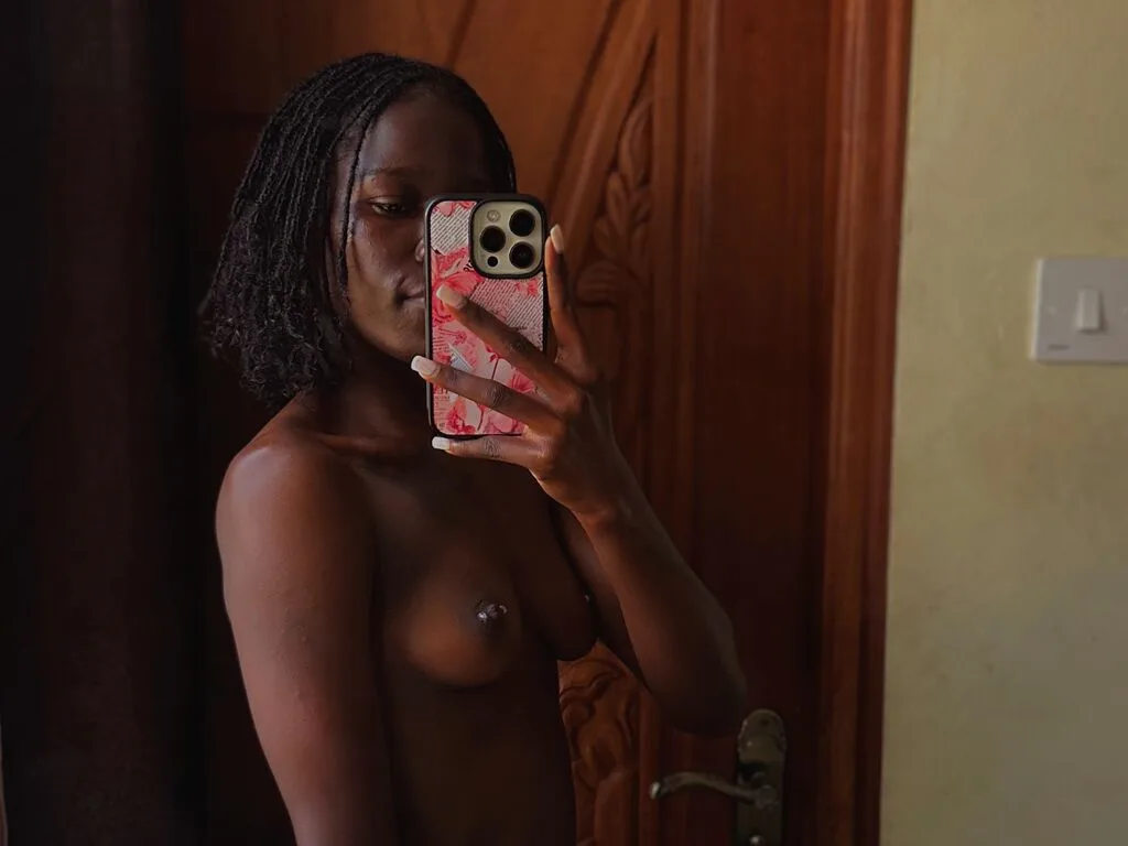 HollyBeatrix takes a mirror selfie while posing naked with her dark braided hair.