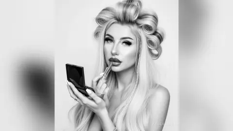 Glamorous blonde woman applying dark lipstick in a high-fashion studio portrait.