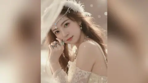 Ethereal woman in white lace gown and feathered headpiece posing with butterfly rings in soft dreamy lighting.