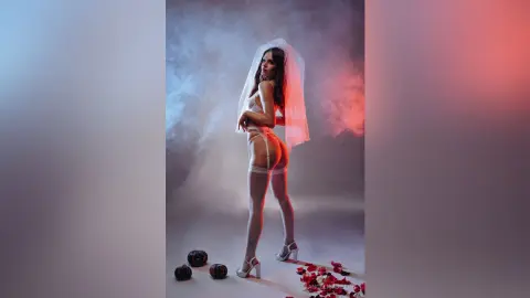 Elegant woman in white lace lingerie and stockings posing amidst dreamy red and blue studio smoke.