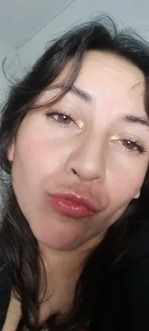 Vanebrown87 makes a pouty face at the camera with her dark hair framing her face.