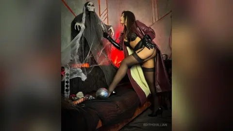 Woman in gothic lingerie and a long coat posing with a spooky skeleton decoration in a dark, moody setting.