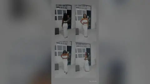 Smiling woman in a white two-piece crop top and maxi skirt outfit standing in a bright modern room.