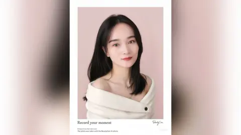 Smiling young woman in a white off-the-shoulder top posing against a soft pink background for a portrait.