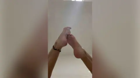 SevenElete shows off her bare feet and soles against a plain white background.