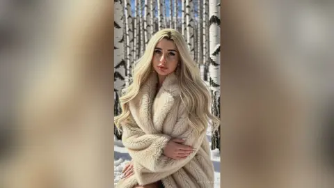 Blonde woman in a cozy cream faux fur coat posing in a snowy birch forest for a winter fashion look.