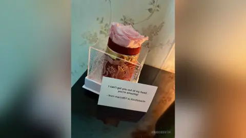 A gift from mario957 to KimRoberth featuring a pink frosted cupcake in a clear box with a handwritten note.