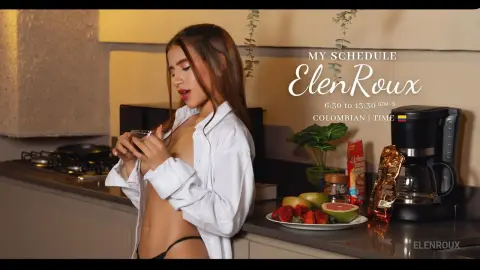 Young woman in a white button-down shirt sipping coffee in a modern kitchen during a morning routine.