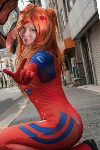 Cosplayer in a red and blue superhero bodysuit posing on a city street with long orange hair.