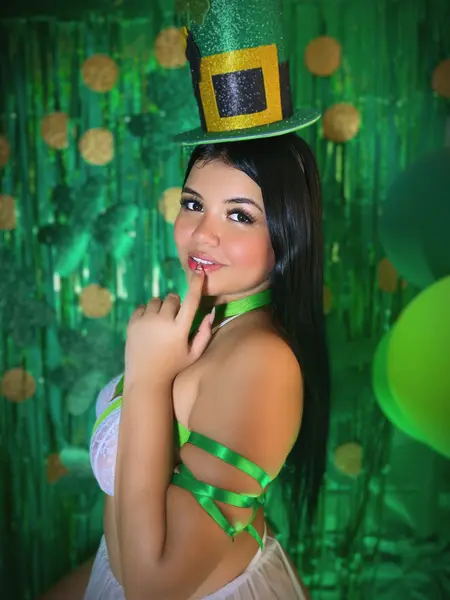Lizz_Tender poses with her eyes closed, running her hands up her neck and chin, showing her long dark hair and smooth skin.