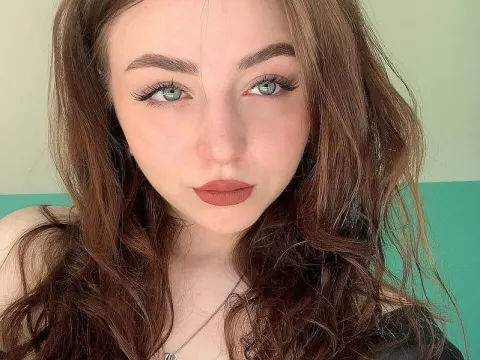 Lois Below — Lois Below looks into the camera with long wavy brown hair and blue eyes.