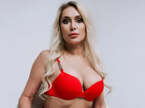Isadora Dunkan — Isadora Dunkan poses in a red bra with blonde wavy hair against a white background.