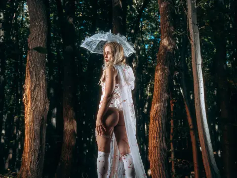 Missha Night — Missha Night stands in a dark forest wearing white lace lingerie and a sheer lace parasol.