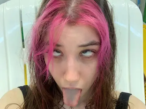 Runo Misaki — Runo Misaki with pink hair looks up while sticking her tongue out at the camera.