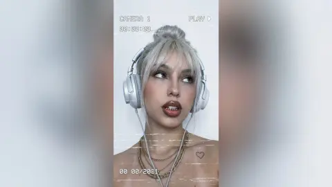 Young woman with silver hair and headphones posing in a dreamy, cinematic aesthetic.