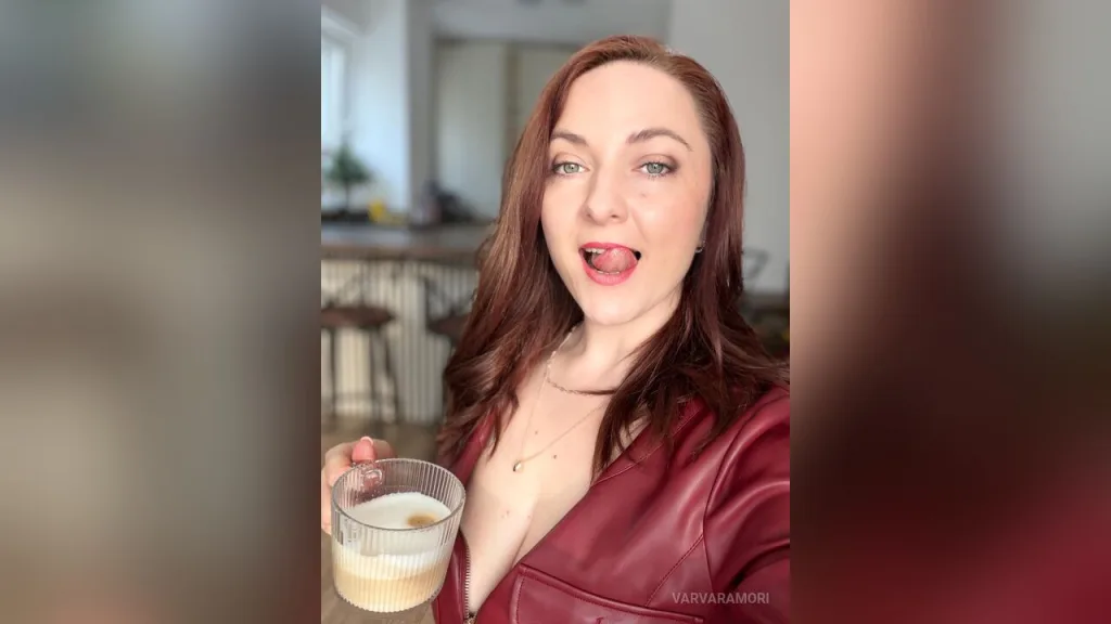 VarvaraMori — VarvaraMori winks and licks her lips while holding a latte in a red leather jacket.