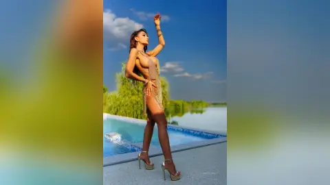 Anastasia stands poolside in a gold fringe bodysuit, posing with one arm raised against a blue sky.
