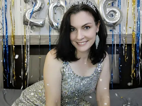 Smiling woman in a silver sequin dress celebrating New Year's Eve with festive decorations.