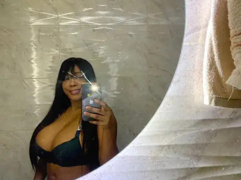 Tyfaniebony — Smiling woman in a black lace bra taking a mirror selfie in a bright, tiled bathroom.