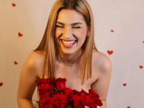 Smiling blonde woman in a romantic setting holding a bouquet of red roses for Valentine's Day.