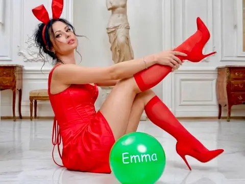 loveSQUIRTS — Glamorous woman in a red bunny outfit and high boots sitting in a white classical room with a green balloon.