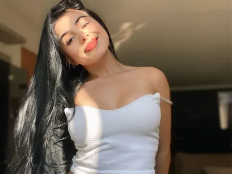 EmmaWoodL — EmmaWoodL smiles at the camera while wearing a white tube top and showing off her long black hair.