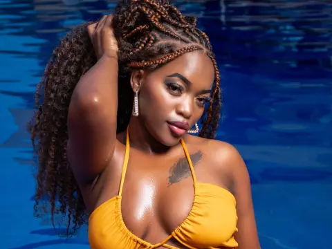 Beautiful woman with long braids in a yellow bikini relaxing by a blue swimming pool.
