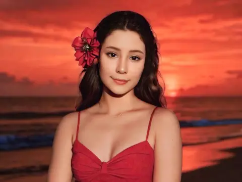 SweetTulip — Young woman in a red sundress with a flower in her hair at sunset on a tropical beach.