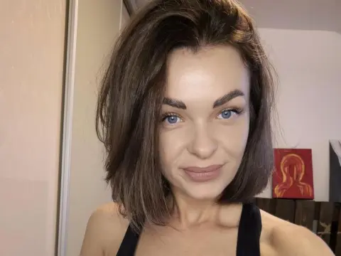 AvaCarterr — Smiling young woman with brown hair in a black tank top posing for a casual indoor selfie.