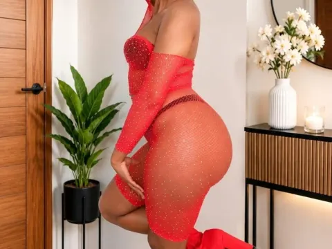PeachyCheeksx — PeachyCheeksx poses in a sheer red mesh dress that shows off her curves and body.