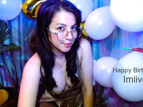 Deb0rahW0nka_ — Smiling woman in a gold dress celebrating a birthday with white balloons in a festive blue setting.