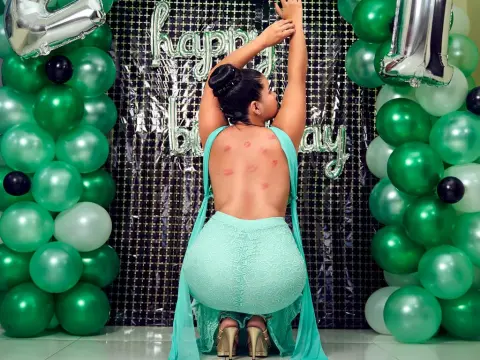 Princes_Jasmine — Princes_Jasmine poses with her back to the camera, wearing a tight mint green dress and gold heels in front of a birthday backdrop.