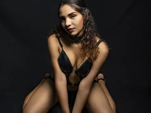 Beautiful woman in black lace lingerie posing against a dark background with a moody, sensual aesthetic.