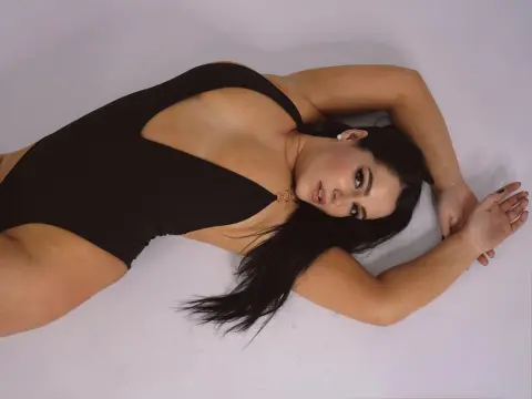 JenifferGrey — Curvy woman in a black bodysuit lying on a white studio background with a relaxed, moody aesthetic.